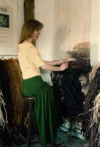 Nina handweaves her tapestries on a simple wood frame of strung sisal without a loom.